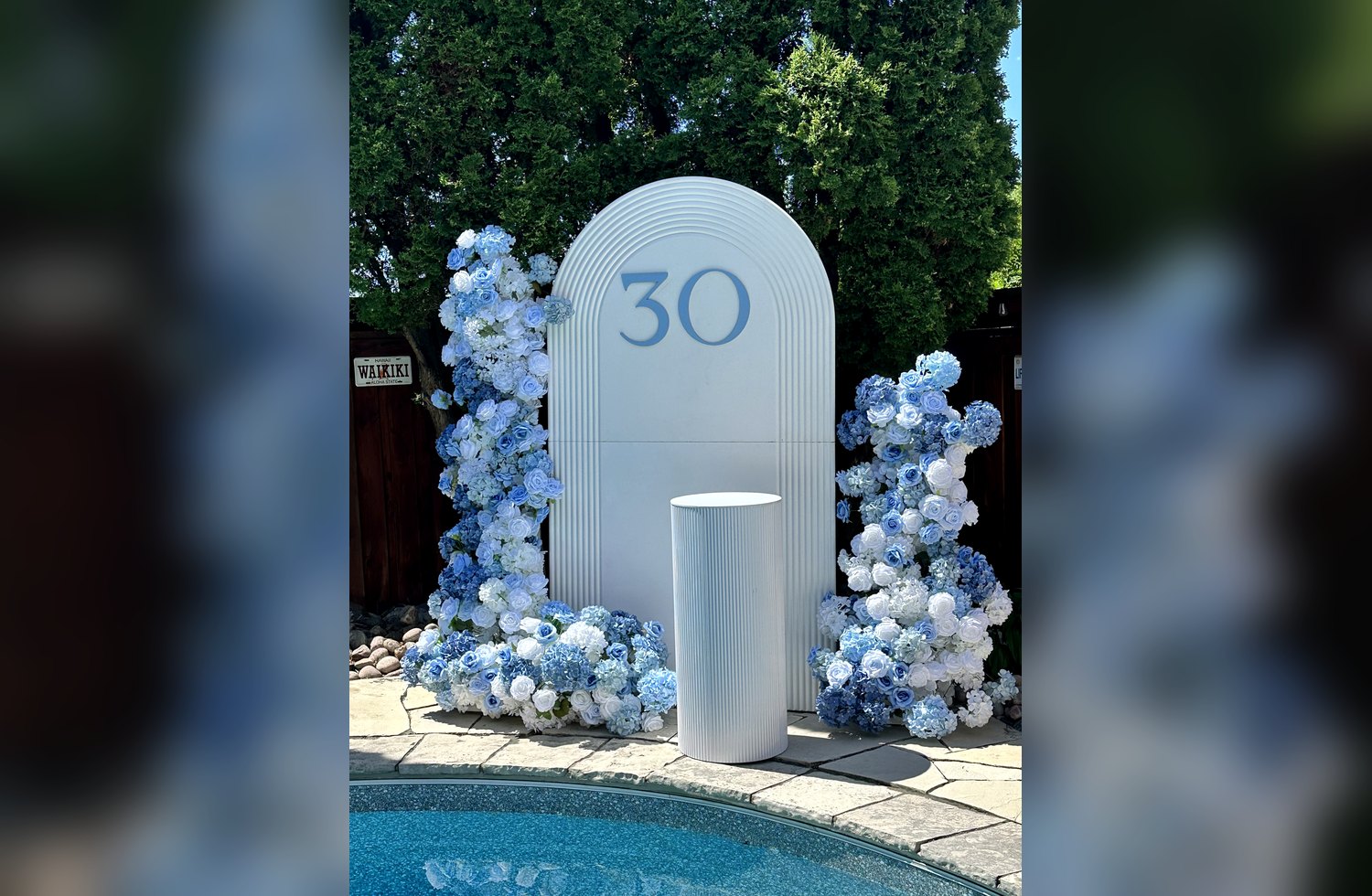Blue and white poolside event display with florals